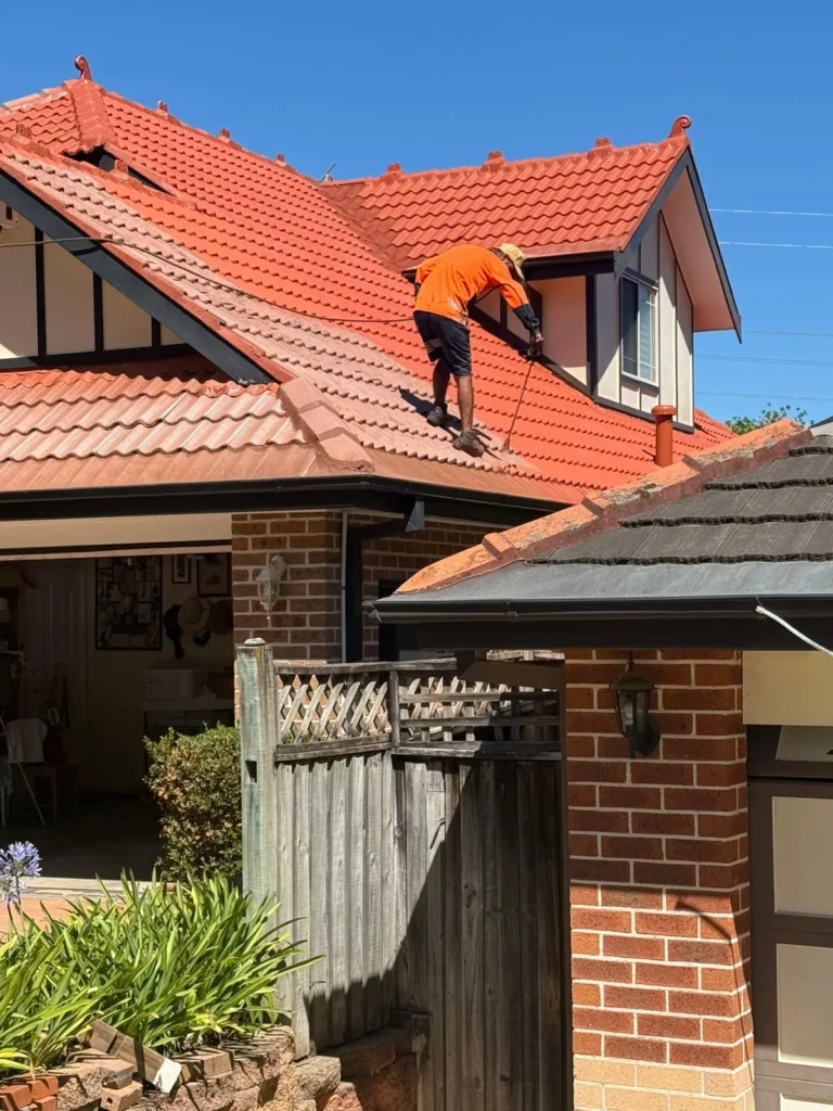 JetBlast Pressure Washing Wotk completion -cleaning a red tiled roof on a house.