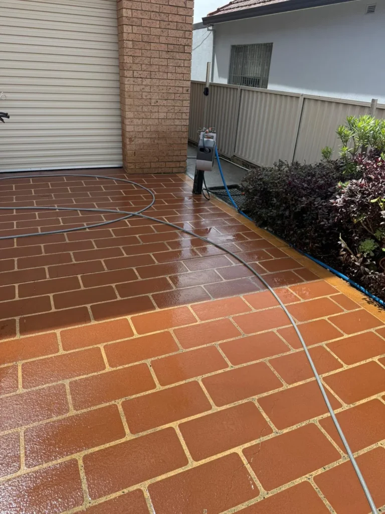 Pressure washed brick patio showcasing enhanced cleanliness and curb appeal, with pressure washing equipment visible, emphasizing maintenance for residential properties in Sydney.